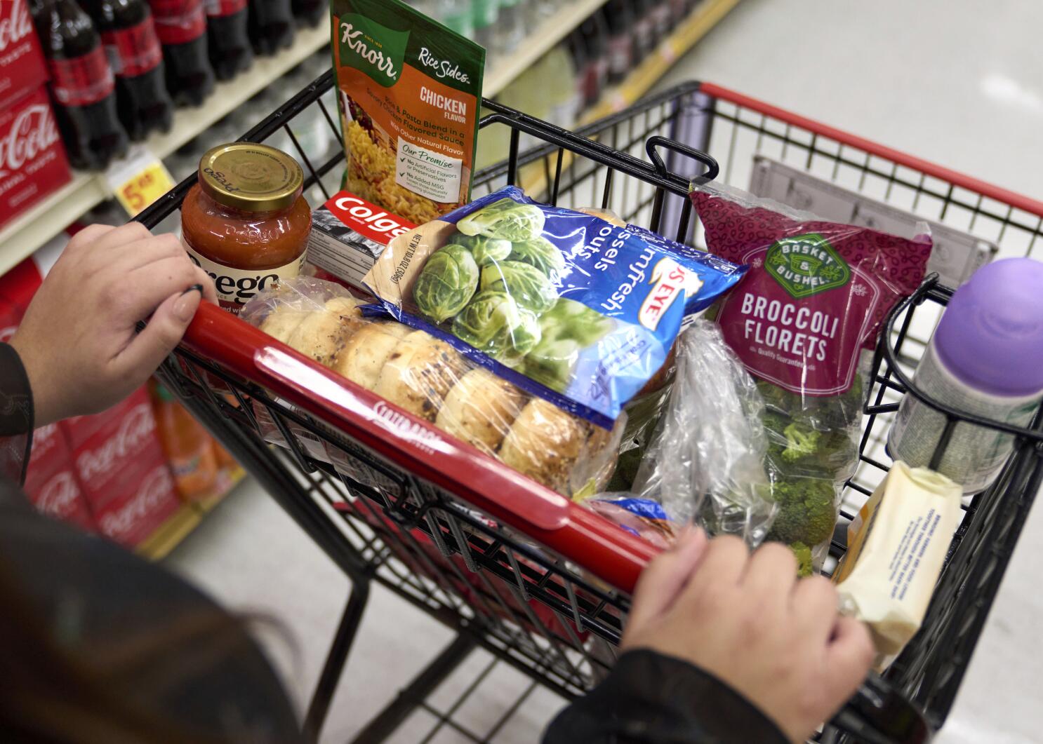 Jaqueline Benitez, who depends on California's SNAP benefits to help pay for food, shops for groceries at a supermarket in Bellflower, Calif., on Monday, Feb. 13, 2023. Nearly 30 million Americans who got extra government help with grocery bills during the pandemic will soon see that aid shrink. (AP Photo/Allison Dinner)